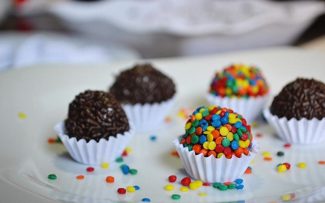 A box of dark chocolate truffles dusted with cocoa